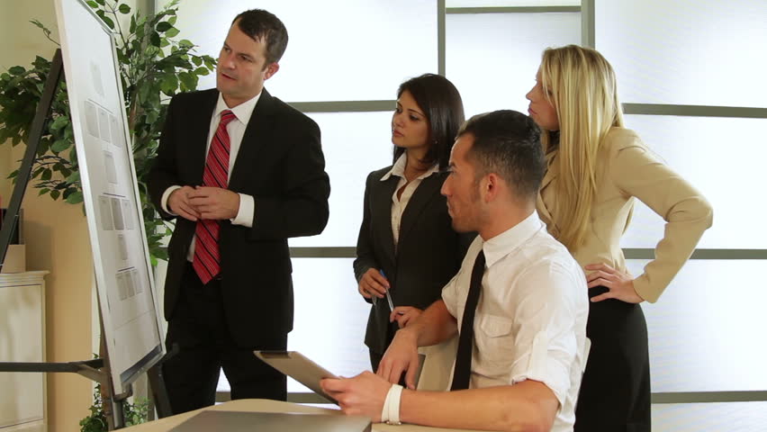 Four attractive business professionals exhibit teamwork as they brainstorm about a project.