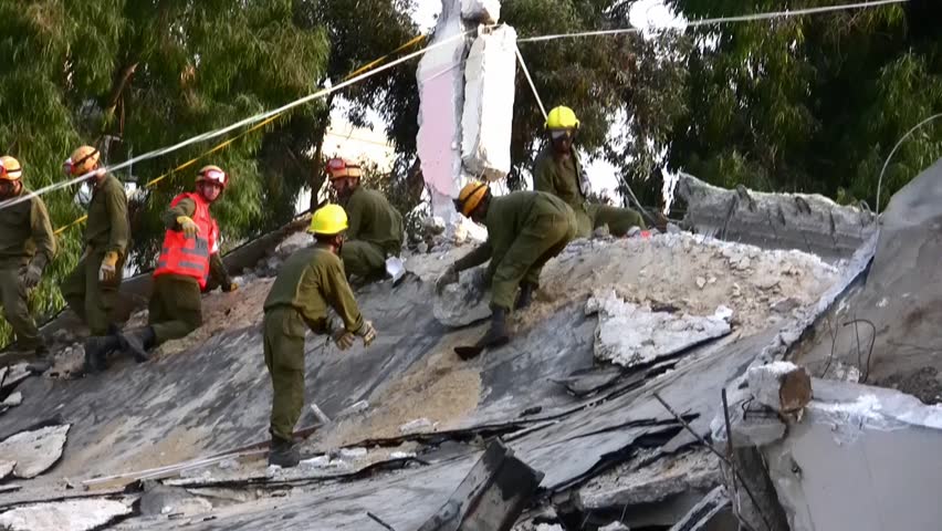HOLON, ISRAEL - OCTOBER 21: Soldier searching for earthquake casualties digging through the rubble during earthquake drill in Holon, Israel, October 21, 2012