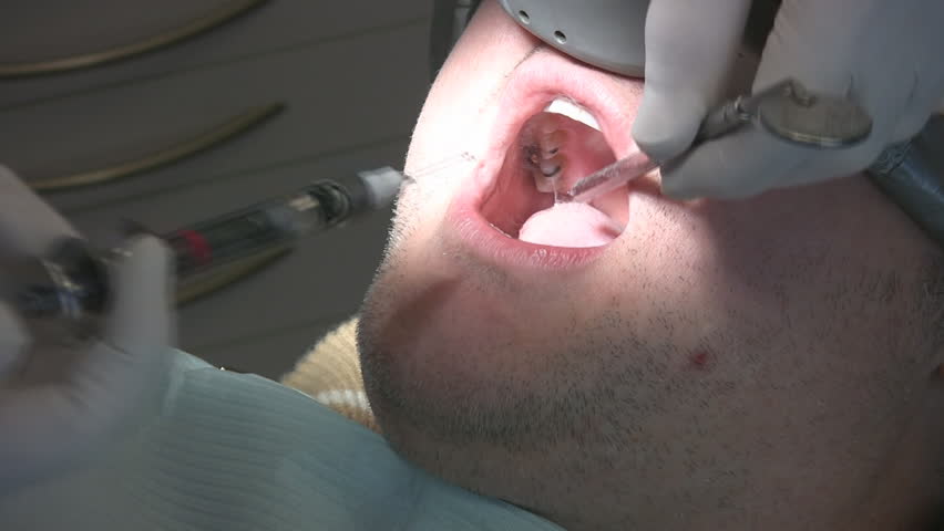 Dental patient gets injection.