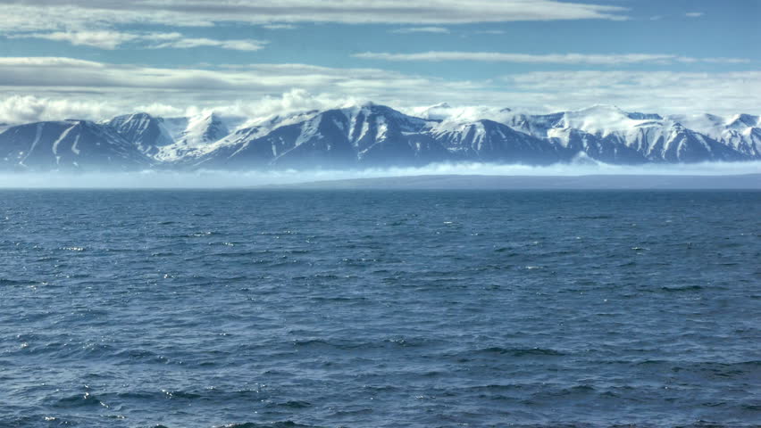 HD video of an ocean in front of a mountain range in Iceland. HDR, HD video