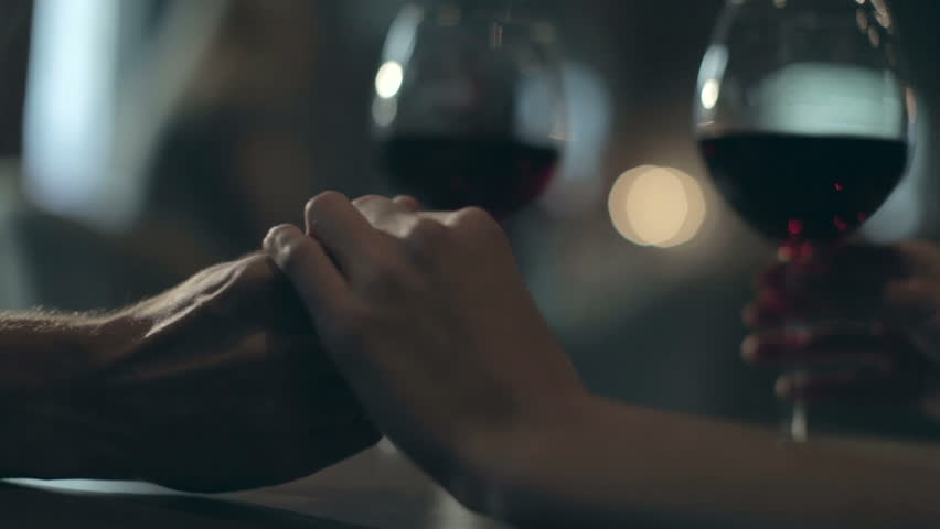 Girl and a guy drinking wine in a restaurant