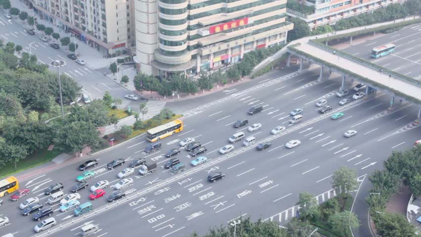 Road traffic with cars and buses on highway at summer day in Guangzhou, China