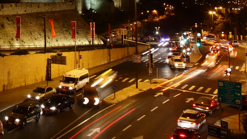 JERUSALEM, ISRAEL - NOVEMBER 01: Drivers, commuters and tourists hurry to their destinations during rush hour near the wall of Jerusalem, time lapse view, Israel, 01 November 2012