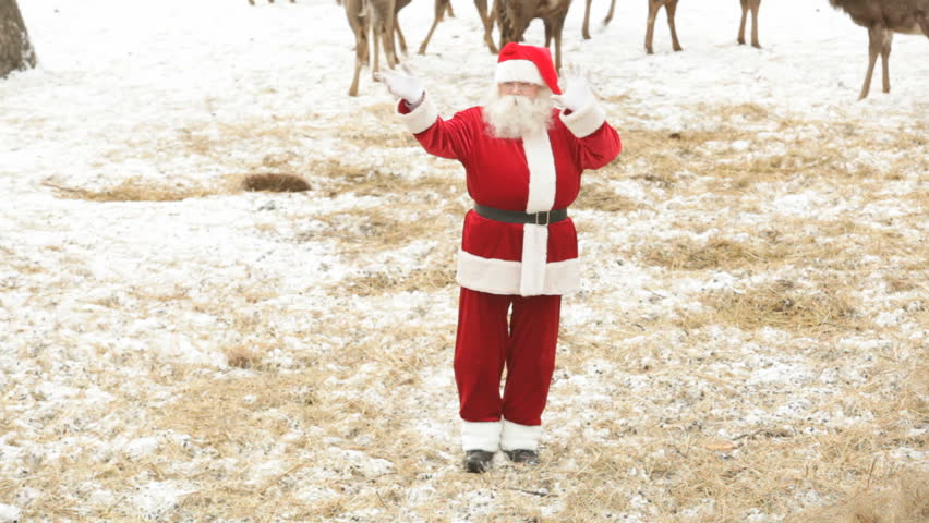 Santa Claus performing modern Christmas dance for his deer
