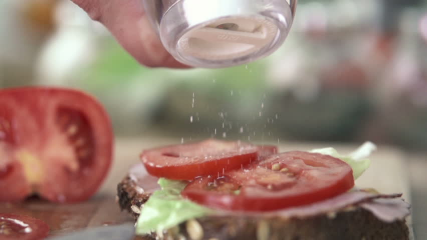 Hand sprinkle salt on sandwich, slow motion shot at 480fps
