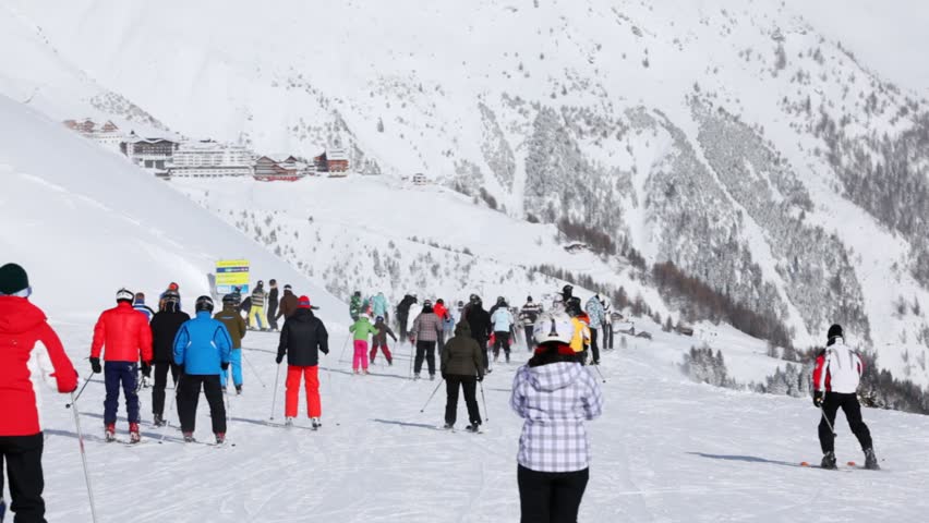 SOELDEN - FEB 16: Many skiers go down on ski route down in sunny weather against mountain slopes, on Feb 15, 2012 in Soelden, Austria
