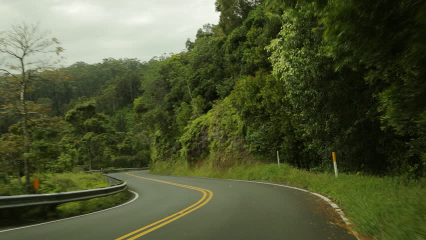 Driving POV on Hana Highway, Maui, Hawaii. Also known as the Road to Hana, the highway is famous for its slow, curving route through dense foliage.
