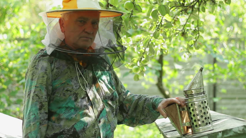 Portrait of beekeeper in his apiary