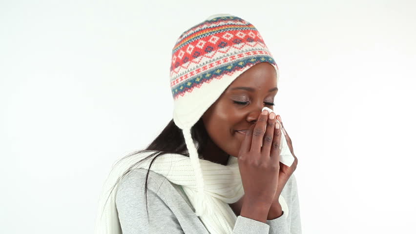 Woman sneezing against white background