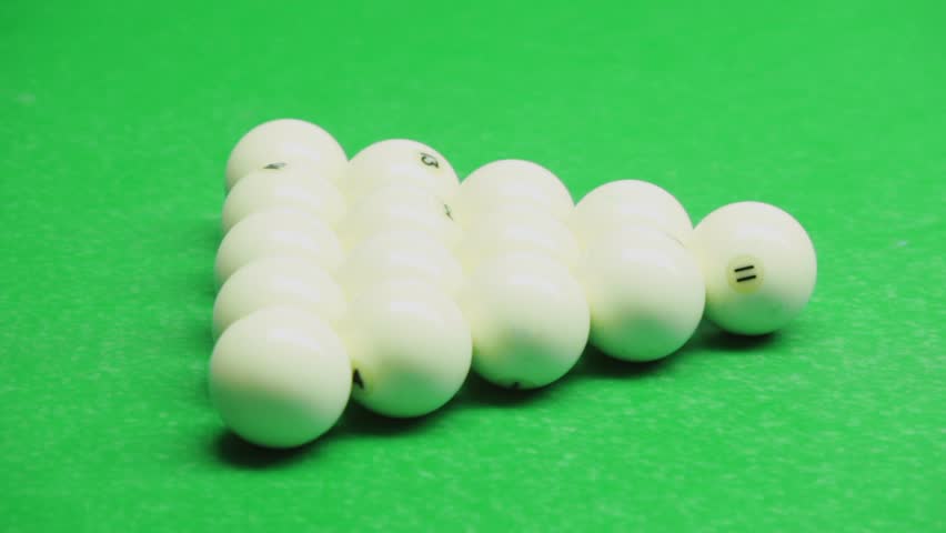 First shot breaks billiard balls set on green table