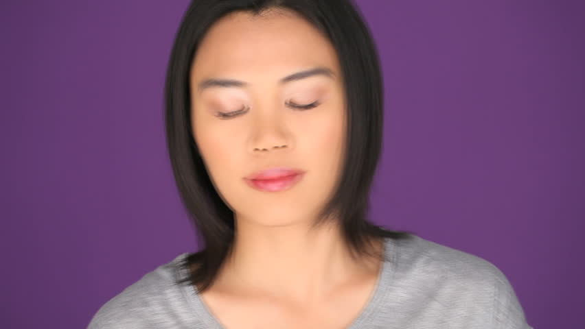Shocked Asian woman on mobile phone