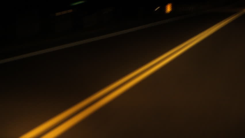 Driving at night on a rural road. Timelapse. Yellow lines and approaching car at end of clip. Ontario, Canada.
