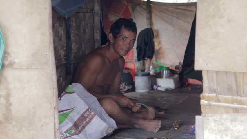 Adult man inside shack in a slum