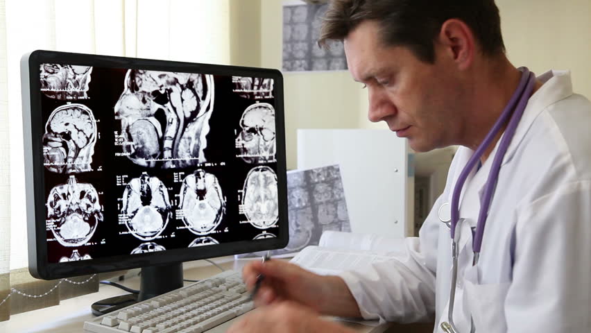 Doctor in Hospital looking at CT scan
