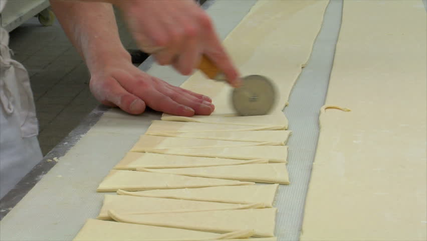 Baker cuts pieces of dough with a rotary cutter. You will find even more GERMAN BAKERY clips in my portfolio!
