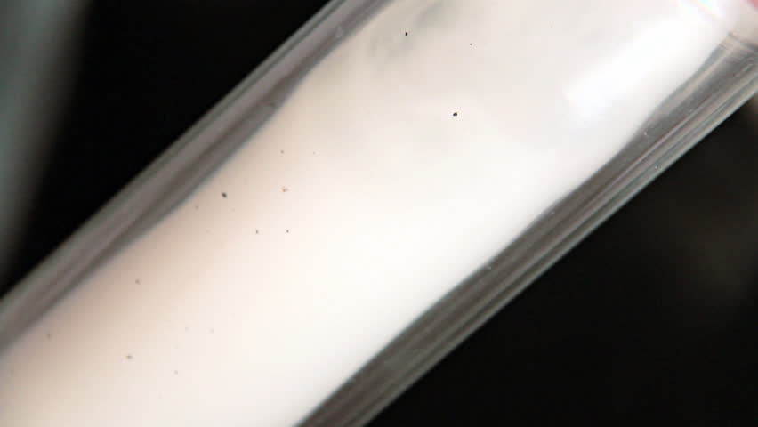 Bong Smoking. Marijuana smoke passing through a glass tube portion of a bong aka water-pipe.