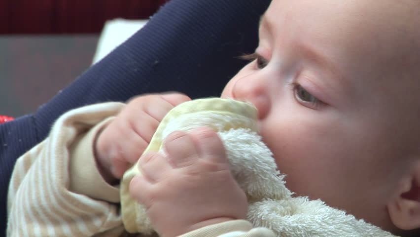 Five months old baby chewing baby-swab

