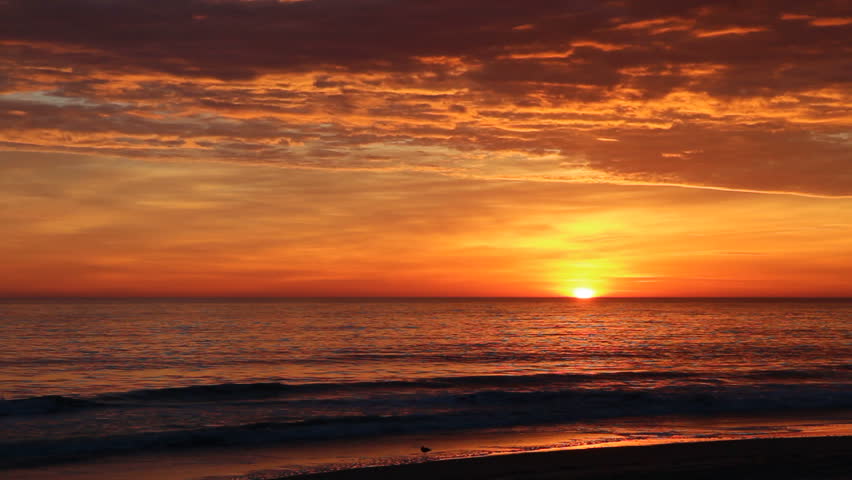 Dramatic orange sunrise over the beach at Nags Head on the Outer Banks of North Carolina to start a beautiful fall day in November