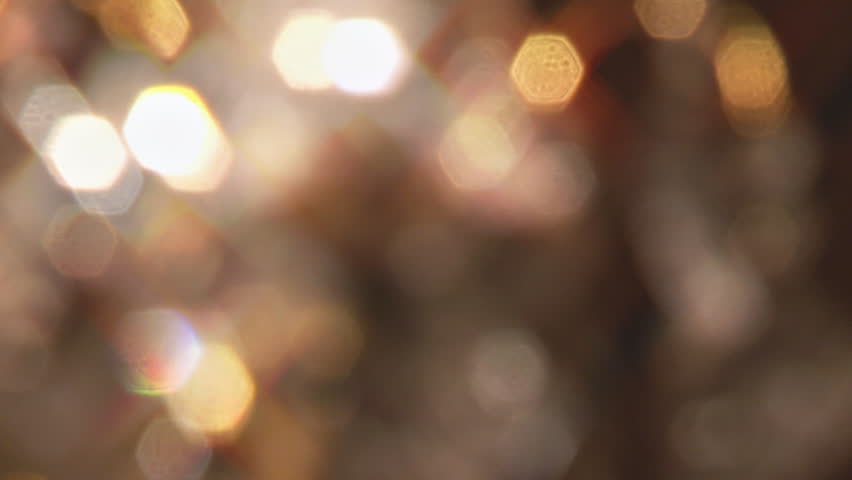 Extreme close-up of a chandelier, rack focus (blur to focus) and pan to swinging crystal.
