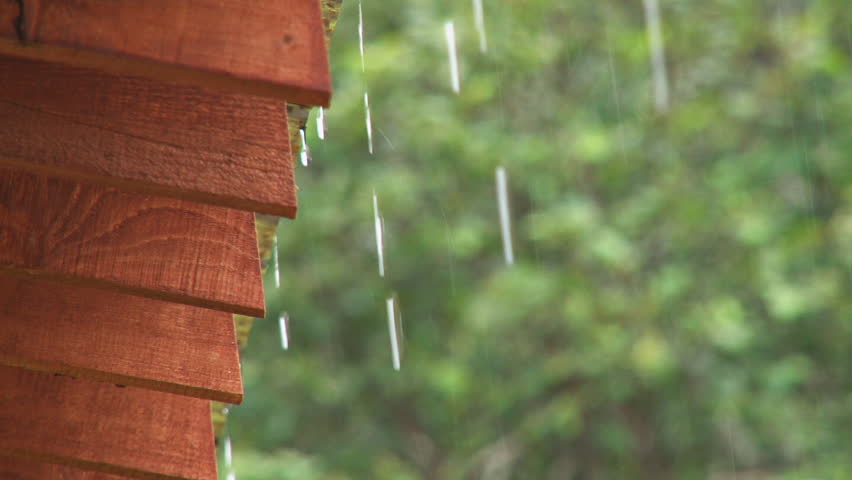 Rainwater dripping off the edge of a roof.