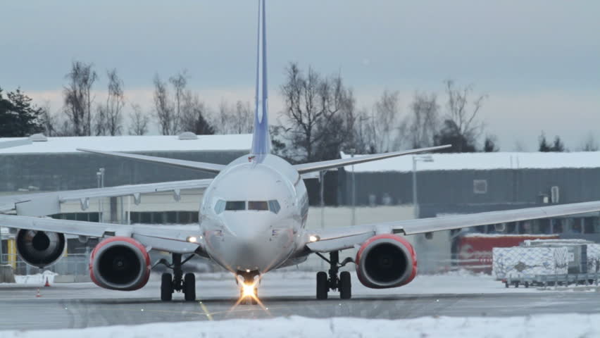 OSLO, NORWAY - DEC 6: Winter, cold weather at OSL Airport, Oslo Norway. Airplane taxing to takeoff position on December 6, 2012.