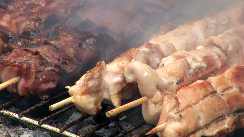 Chicken and pork barbecue cooked outdoors
