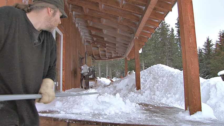 Shoveling the porch. A howling blizzard left a big mess. This is what some people do to deal with snow.