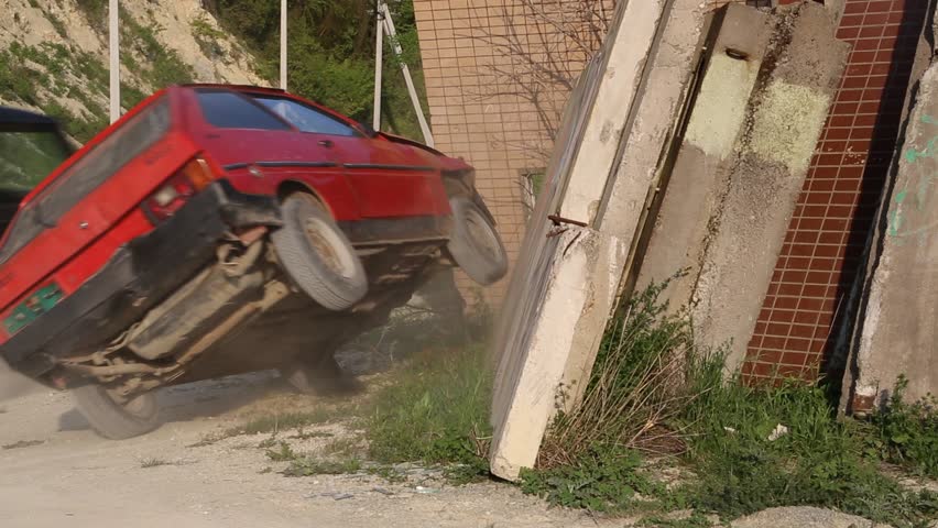 red car crashed into a concrete wall