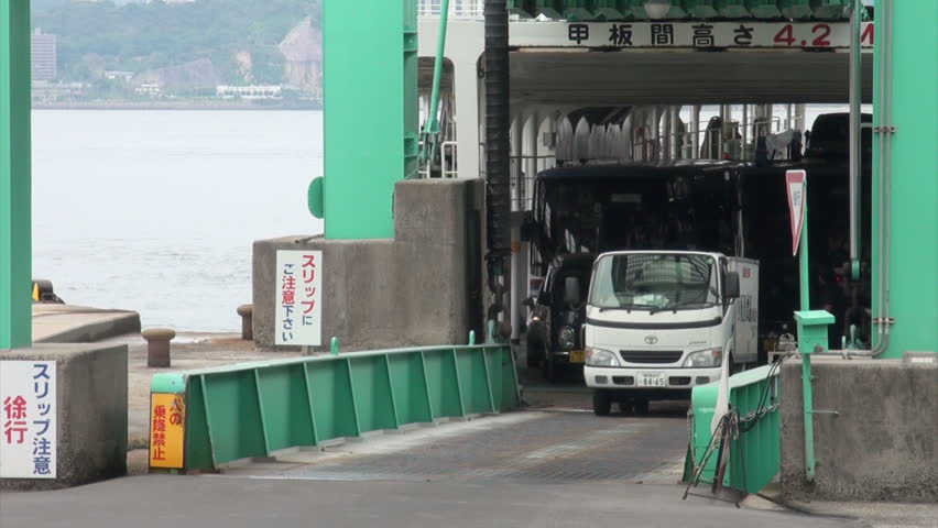 SAKURAJIMA, JAPAN - 30 OCTOBER 2012: Cars, a lorry, and other traffic leaves the ferry on the island of Kagoshima in Southern Japan