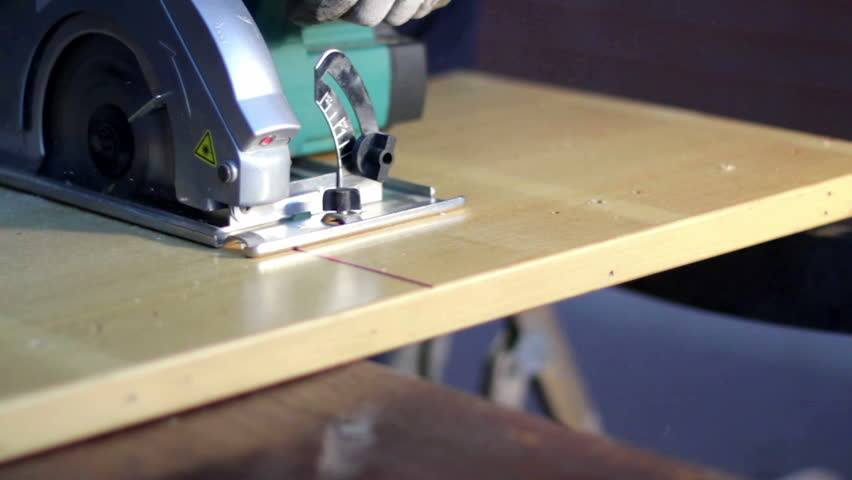 Home improvement - handyman sanding wooden floor in workshop