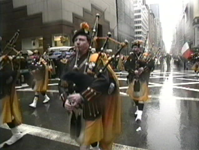 NEW YORK, USA - MARCH 17: Irish descendants march on 5th Avenue and play Irish music during rainy St. Patrick's Day parade, New York, USA March 17, 1995