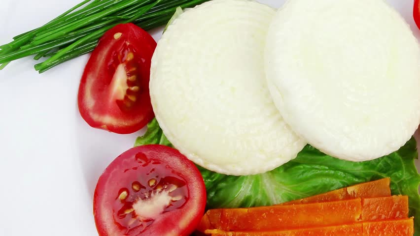 aged cheese : parmesan roquefort and gruyere chops delicatessen cheeses and soft feta on plate isolated over white background