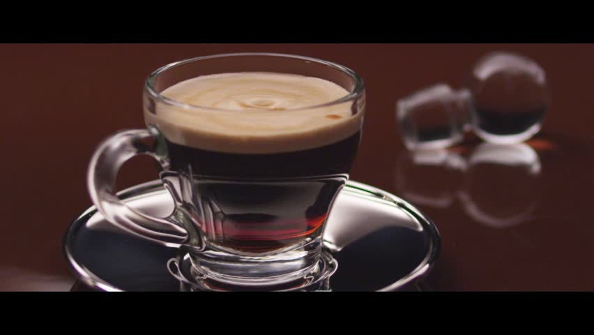 Drops falling into a cup of espresso