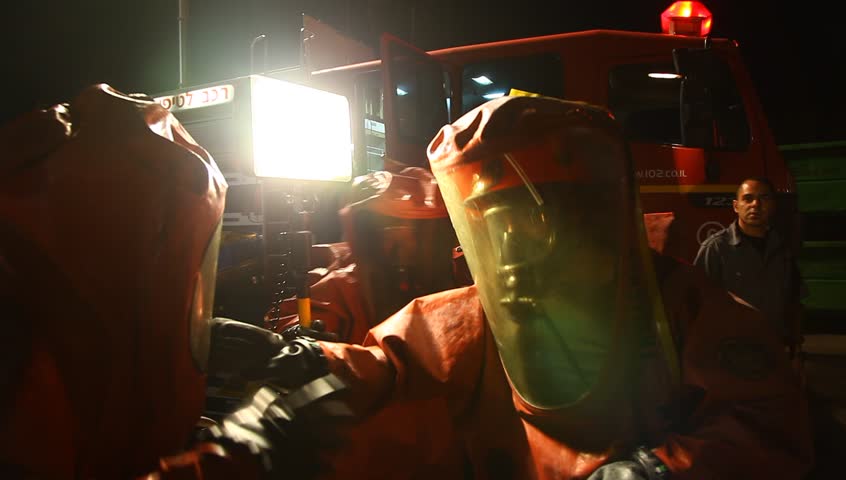 NORTHERN ISRAEL -DECEMBER 17: Firefighters practice to remedy leak accident of corrosive toxic hazardous material Ammonia liquid in seven food factories using protective suites, Northern Israel December 17 2012