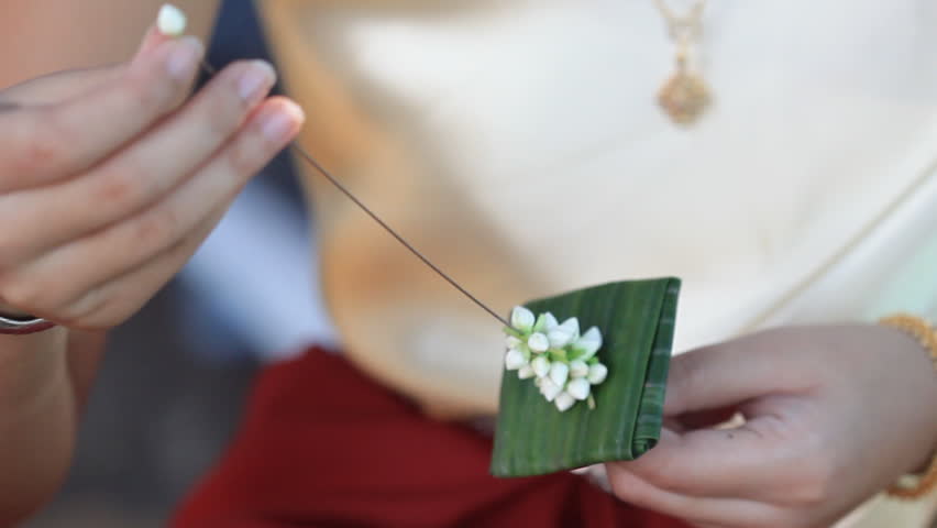 Women make jasmine wreaths 