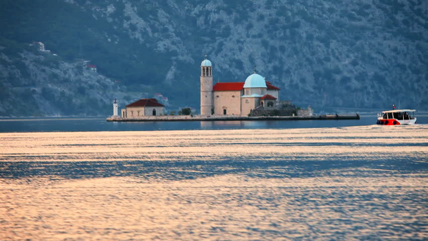 The old church on the island in a sea on foggy mountains background. Montenegro


