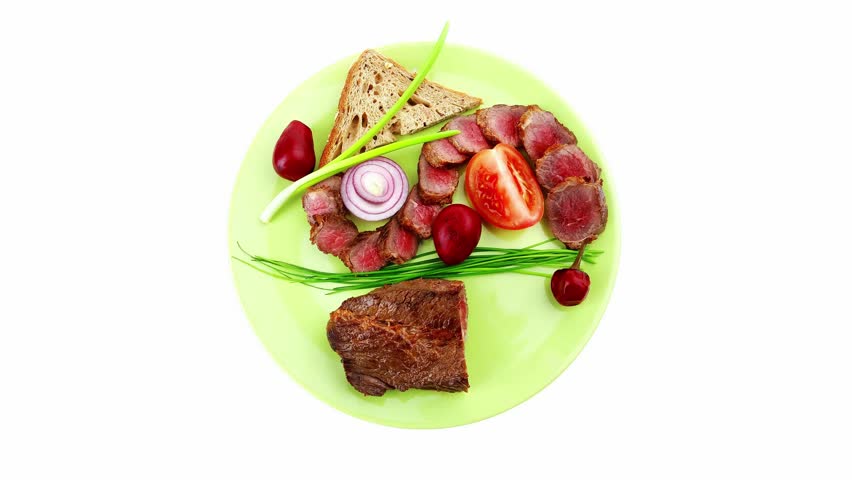 main course : roast red meat slices served on green plate with tomatoes and sprouts isolated on white background