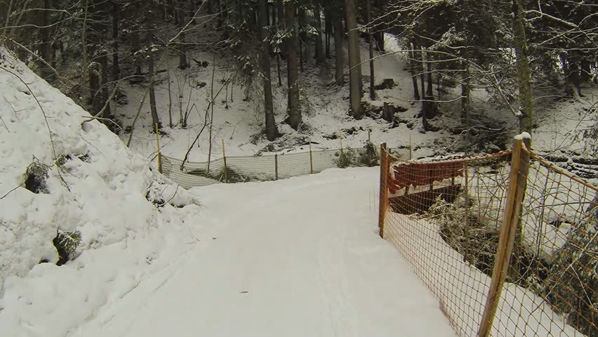Slow motion: riding a snow track on snowboard
