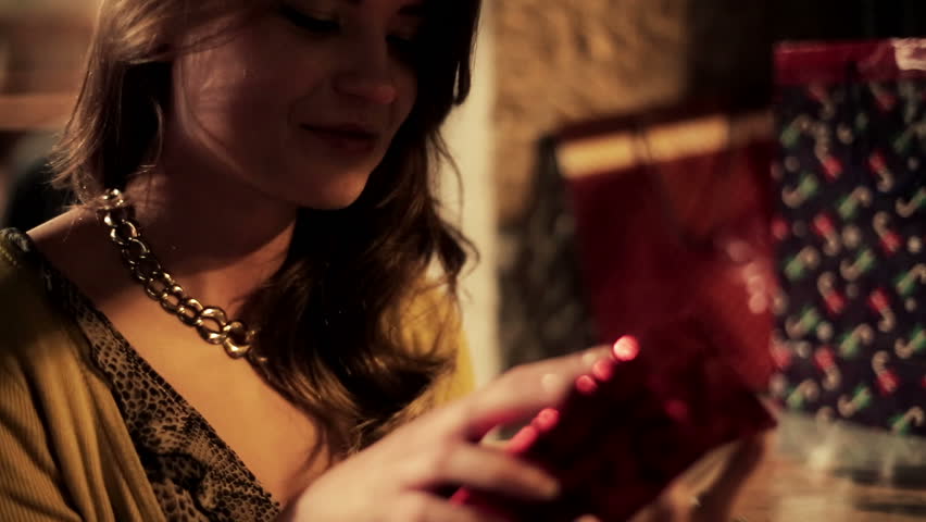 Amazed woman looking at magical gift in the box, steadicam shot
