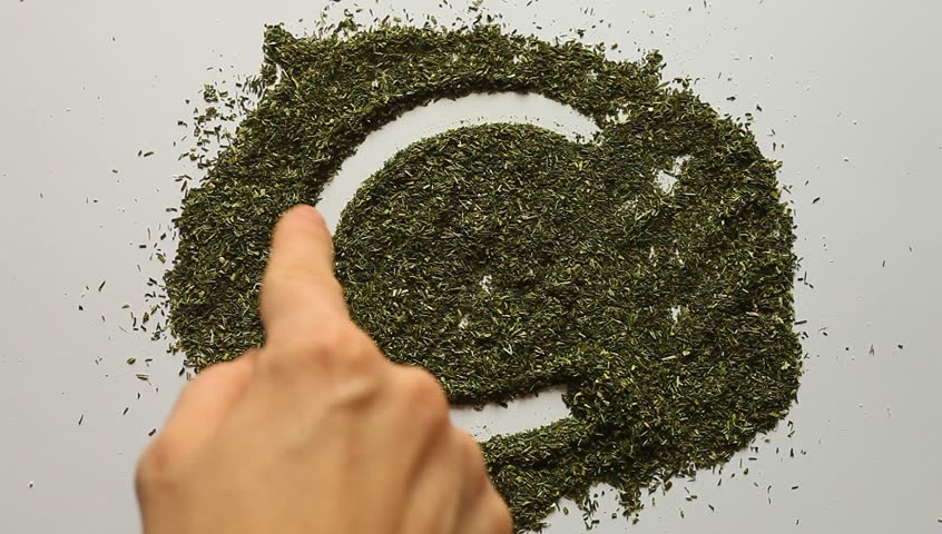 Young adult woman makes euro symbol in dry dill.
