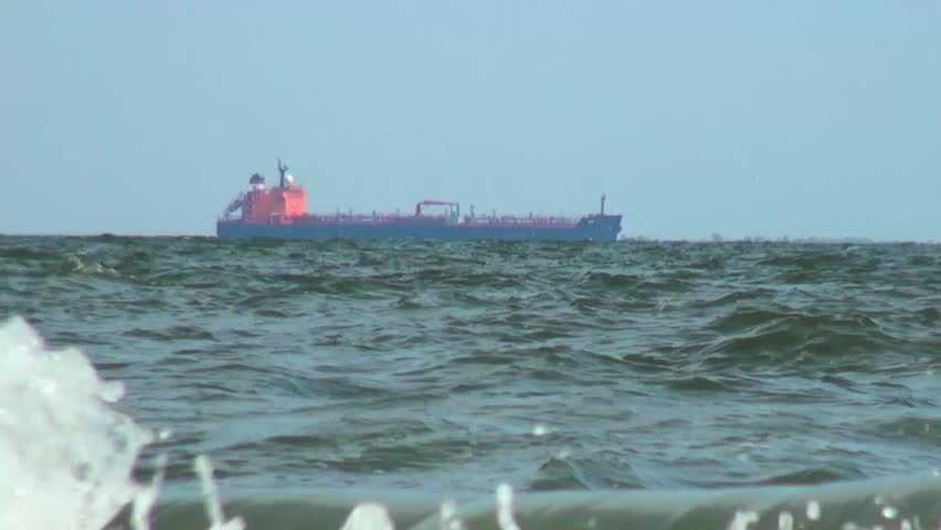 Cargo ship traveling along the sea