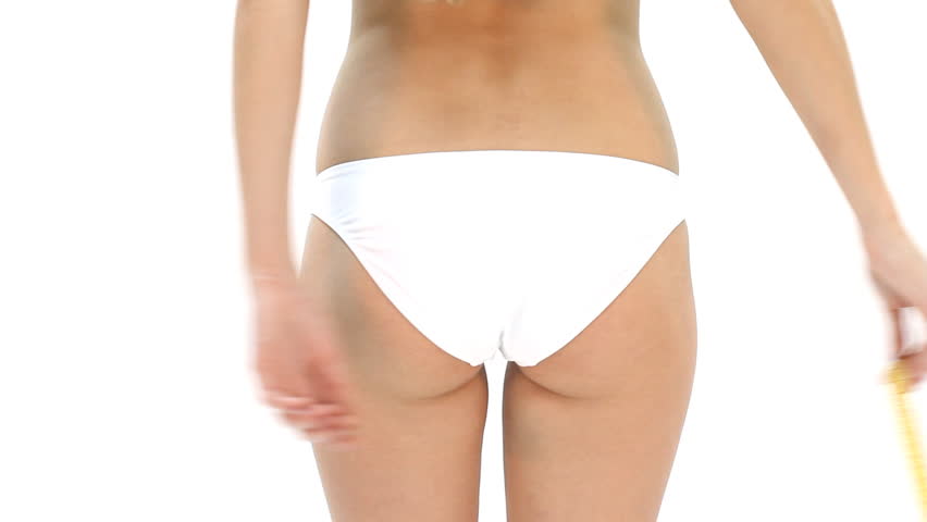 Woman measuring her hip and showing ok sign