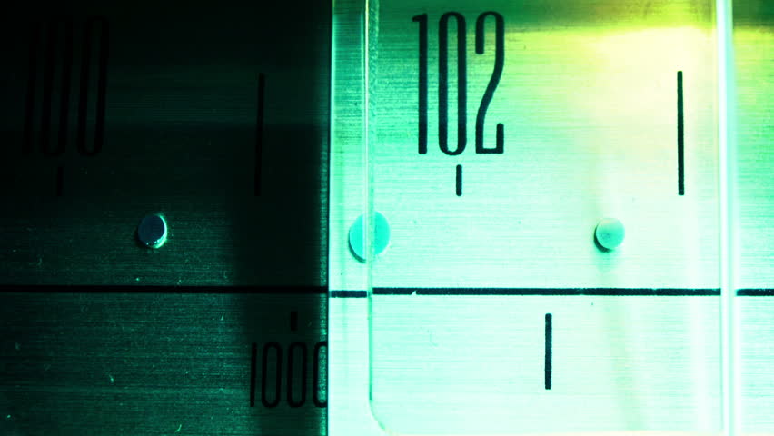 a glowing radio with the marker running through the different stations and frequencies