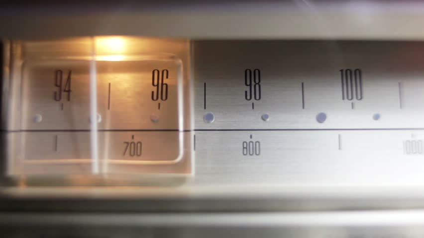 a glowing radio with the marker running through the different stations and frequencies