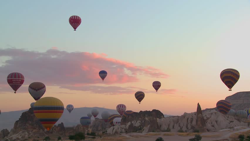 CAPPADOCIA, TURKEY, 2012 Hot air balloons rise from the desert floor against a beautiful sky in Cappadocia, Turkey.