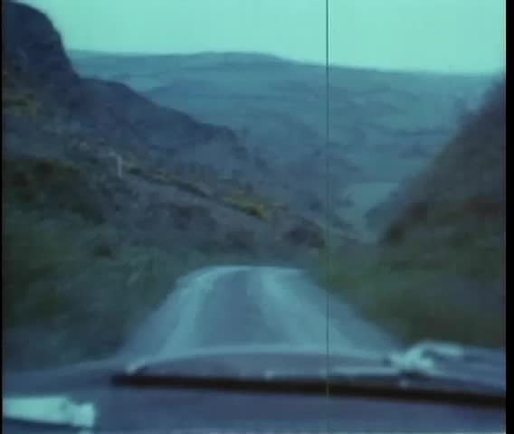 Point of view shot of car driving on twisting mountain road