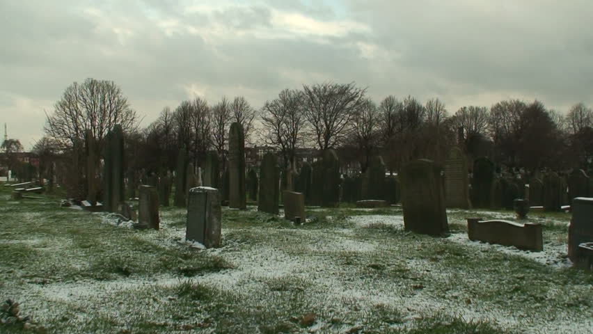  Man fades away walking  in a cemetery