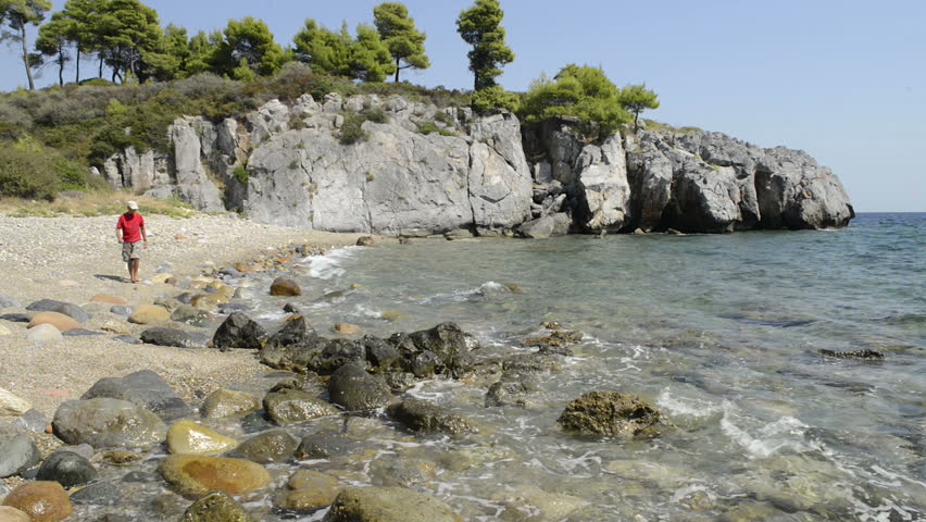 male walking along a sunny beach