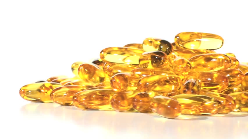 Yellow pill capsules against white V3 - HD LOOP