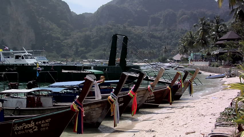 PHI PHI ISLAND, THAILAND - CIRCA FEBRUARY 2009: Decorated Long Boats on Ao Loh Da Lam Beach